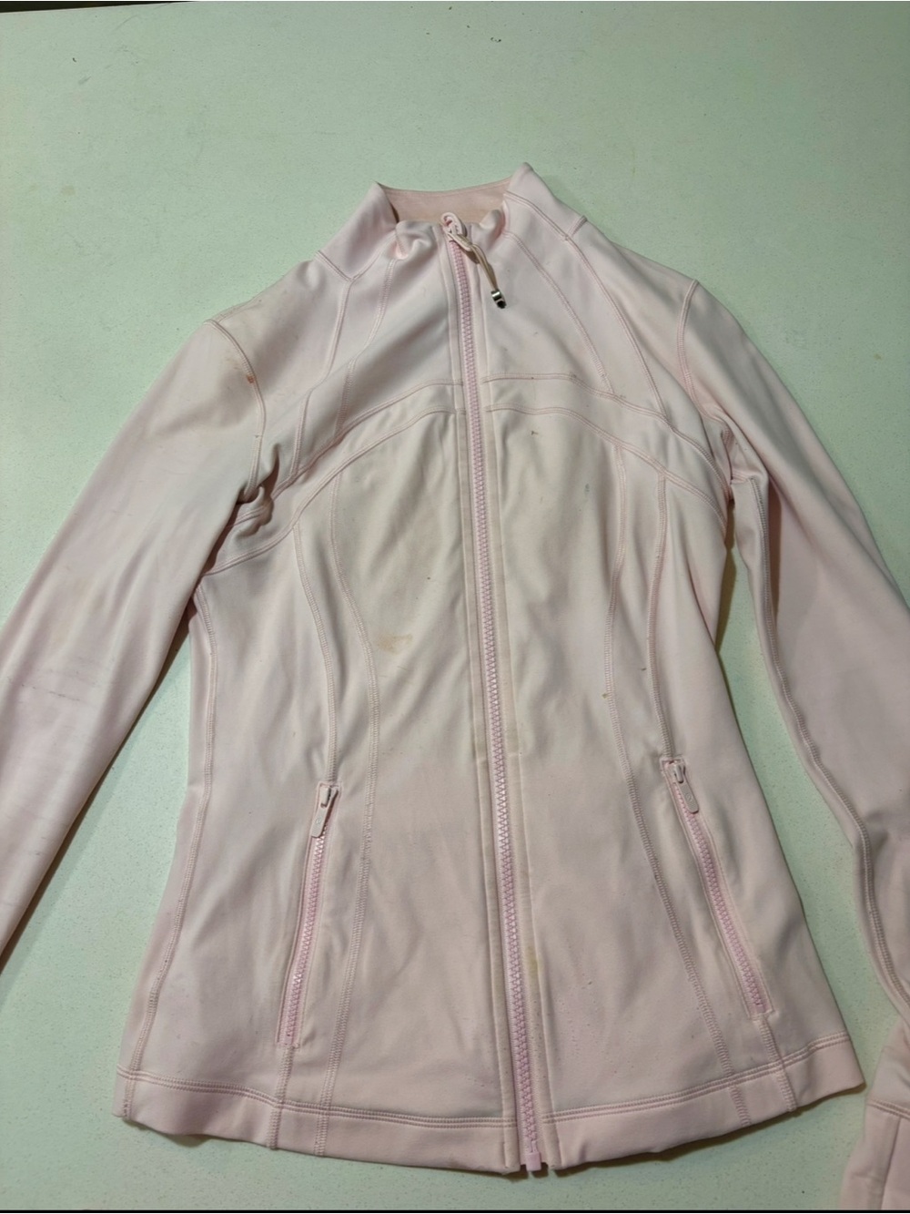 Pink lululemon jacket, strawberry milkshake, some minor stains